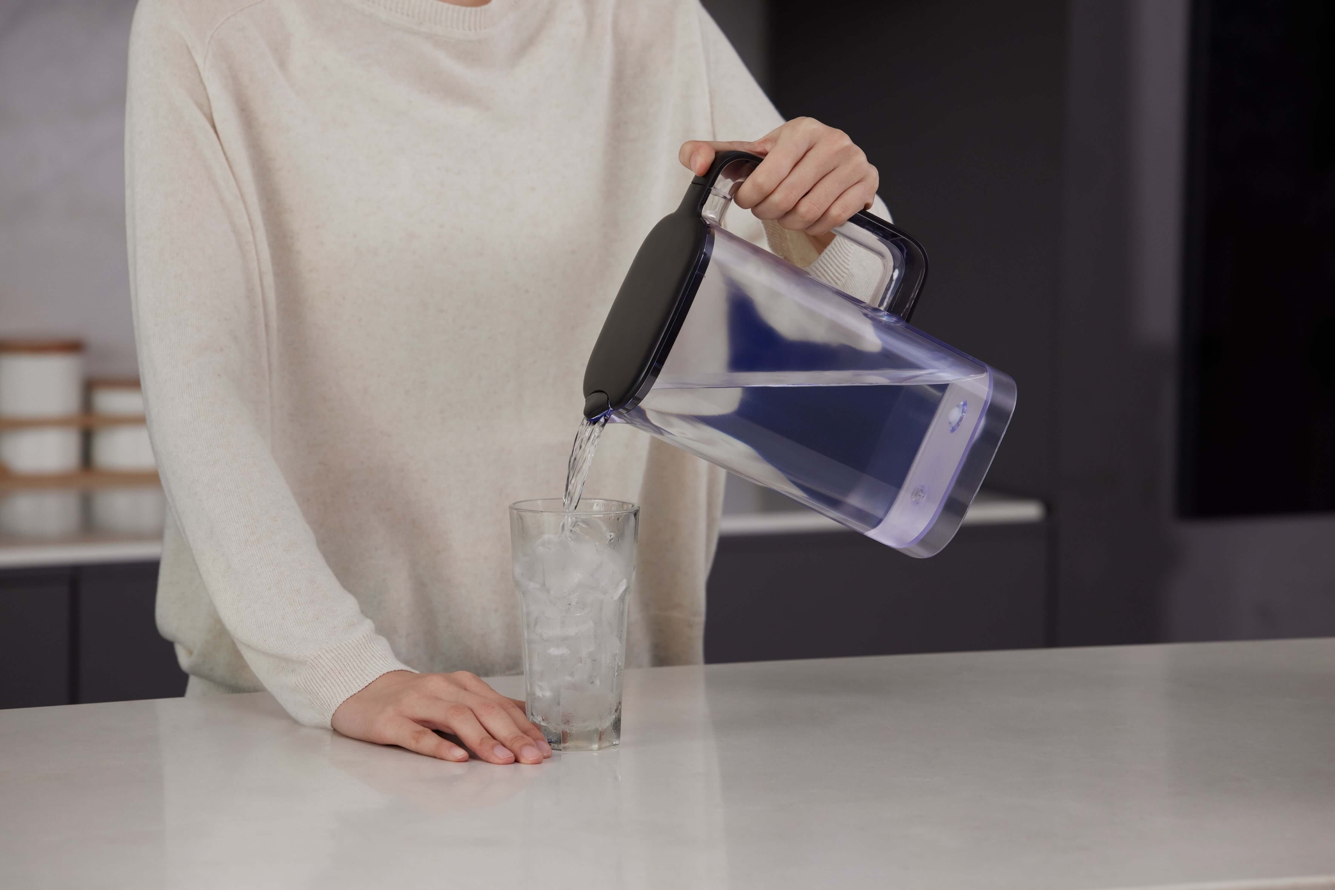 Philips Aquaporin Reverse Osmosis Water Station pouring water into an ice-filled glass.