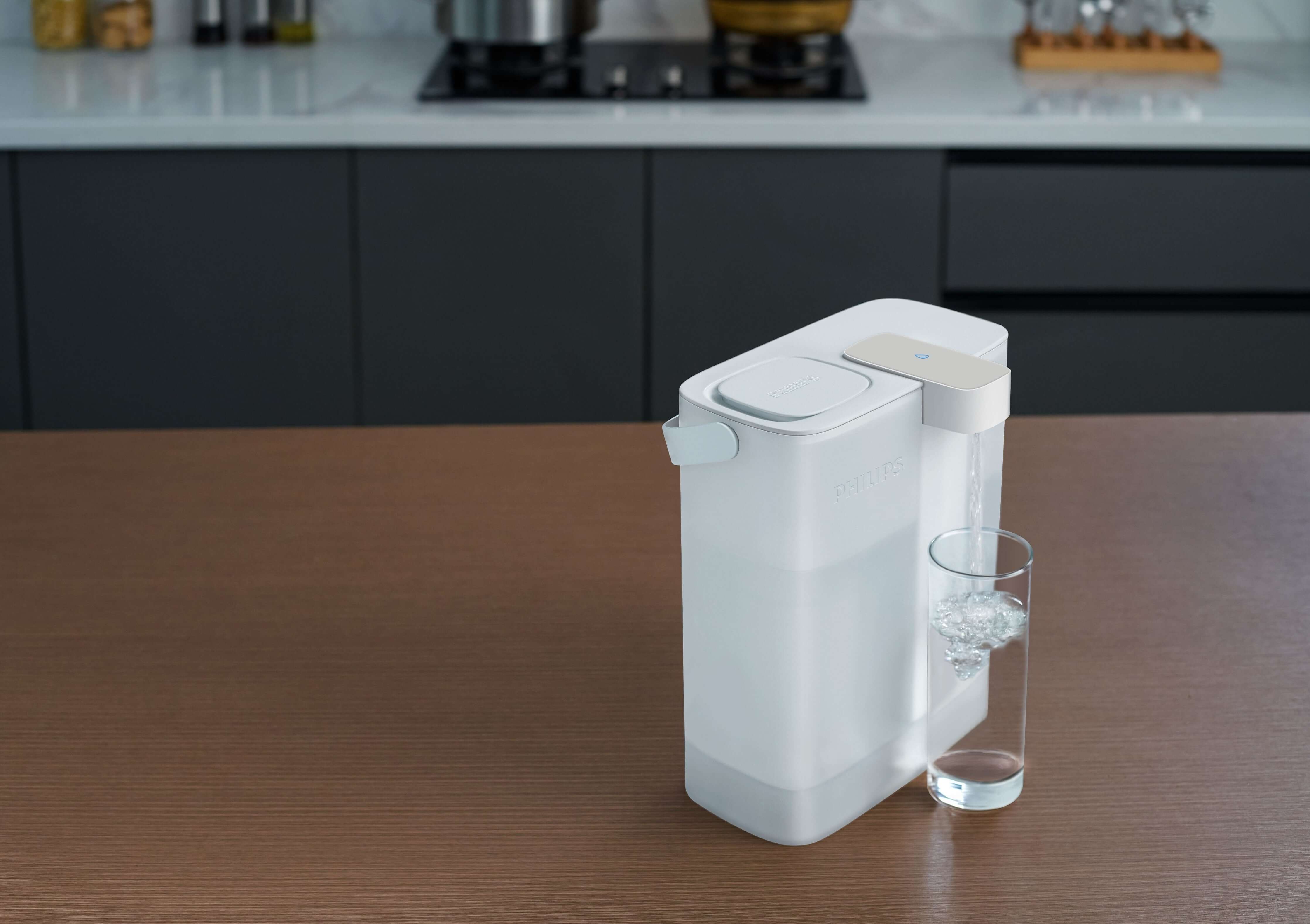 On a wooden countertop sits the Philips Next-generation instant water filter AWP2980WH, featuring advanced Micro X-Clean instant filtration technology, dispensing refreshing water into a clear glass.