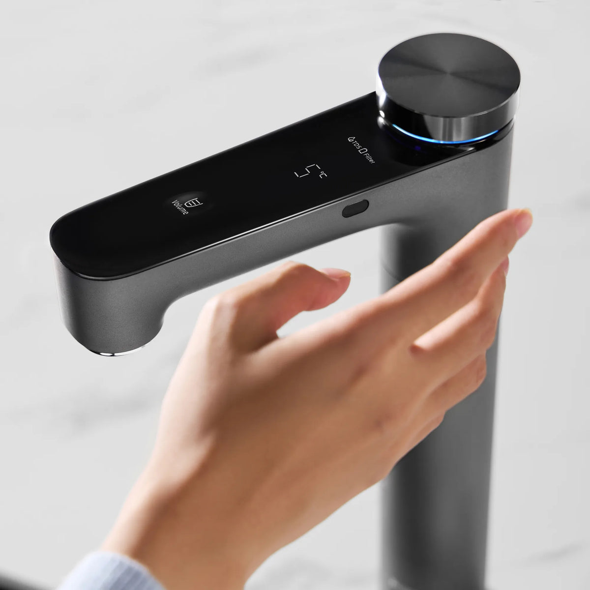 Hand reaching toward the Philips RO tap's infrared sensor, with the display showing 5°C and a blue light ring.