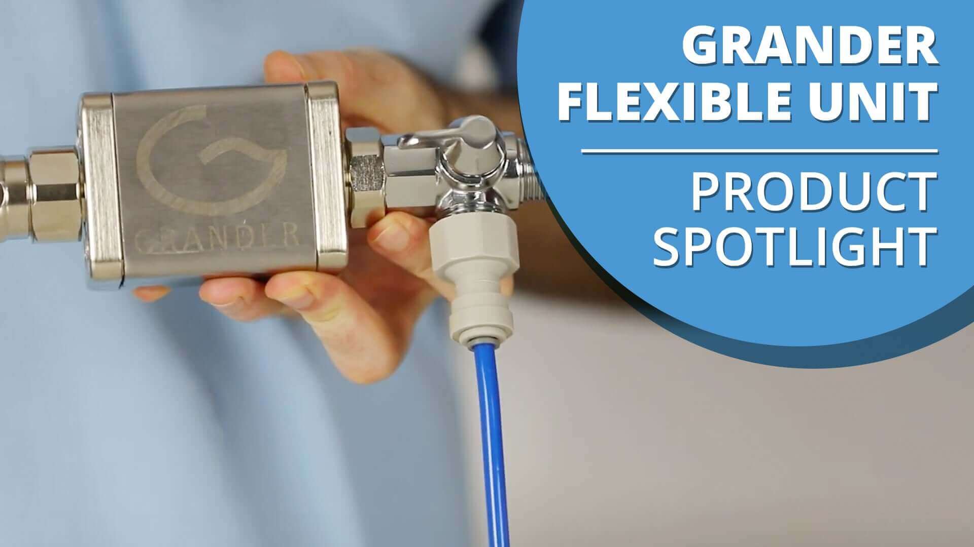 Hand holding a Grander Flexible Unit with a blue hose