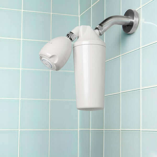 The Aquasana Premium Shower Filter is installed on a blue-tiled bathroom wall. It offers a refreshing shower experience while promoting healthier hair by effectively reducing chlorine levels.