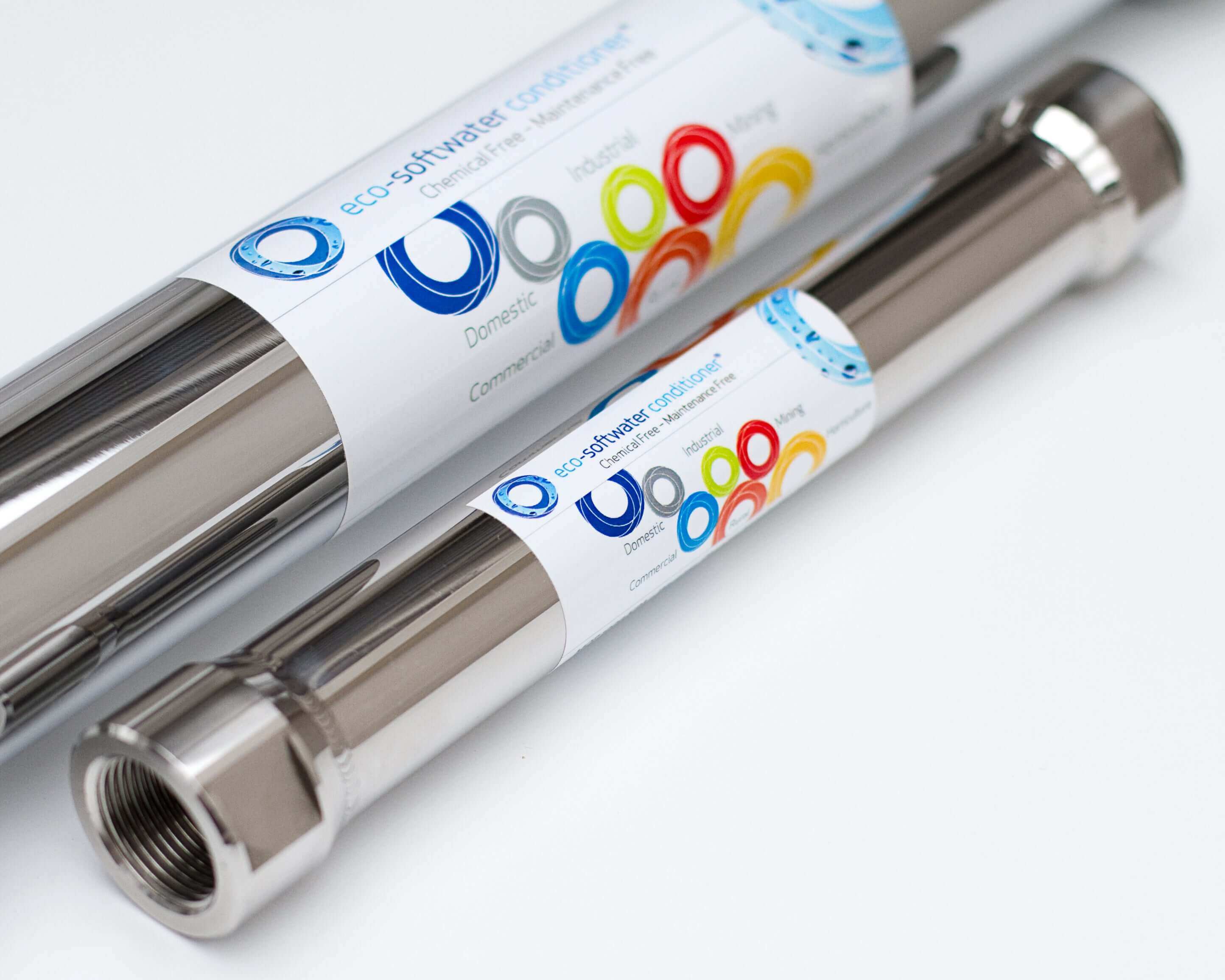 Two reflective Ecosoft Eco20 Whole House Hard Water Conditioners from Ecosoft, featuring colorful labels and a cylindrical stainless steel design.