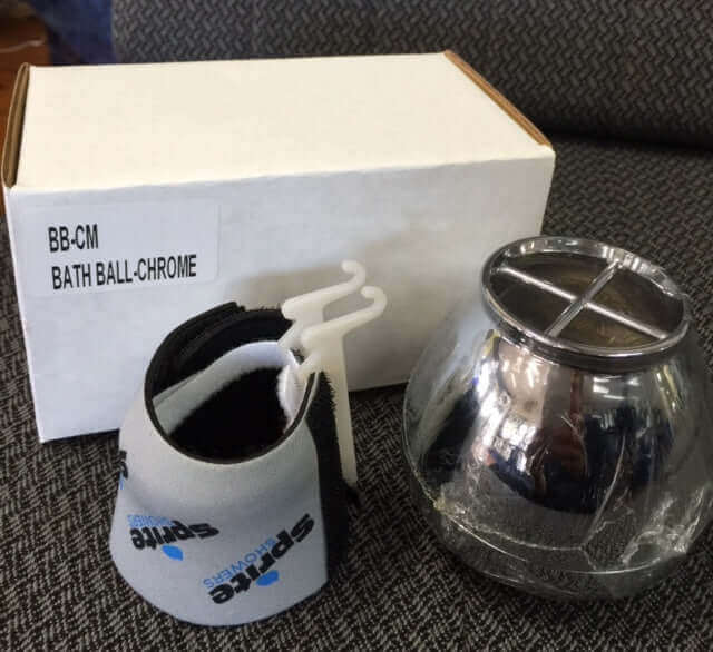 Sprite Bath Ball Water Filter - Chrome/White from Sprite, accompanied by a box and a black and gray fabric strap, displayed on a textured surface.