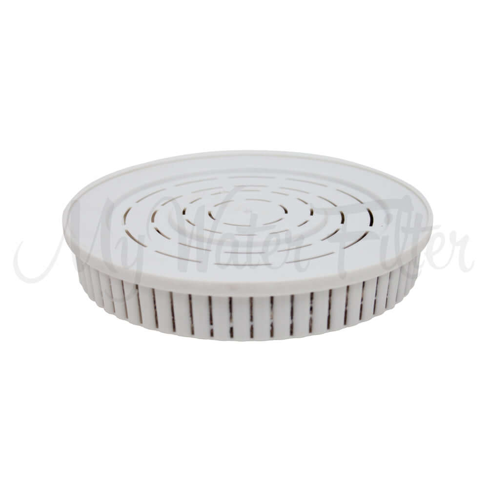 The Drinking Water pH Elevation Mineral Pad in a white circular pad featuring a slotted top design, perfect for benchtop gravity water filtration systems.