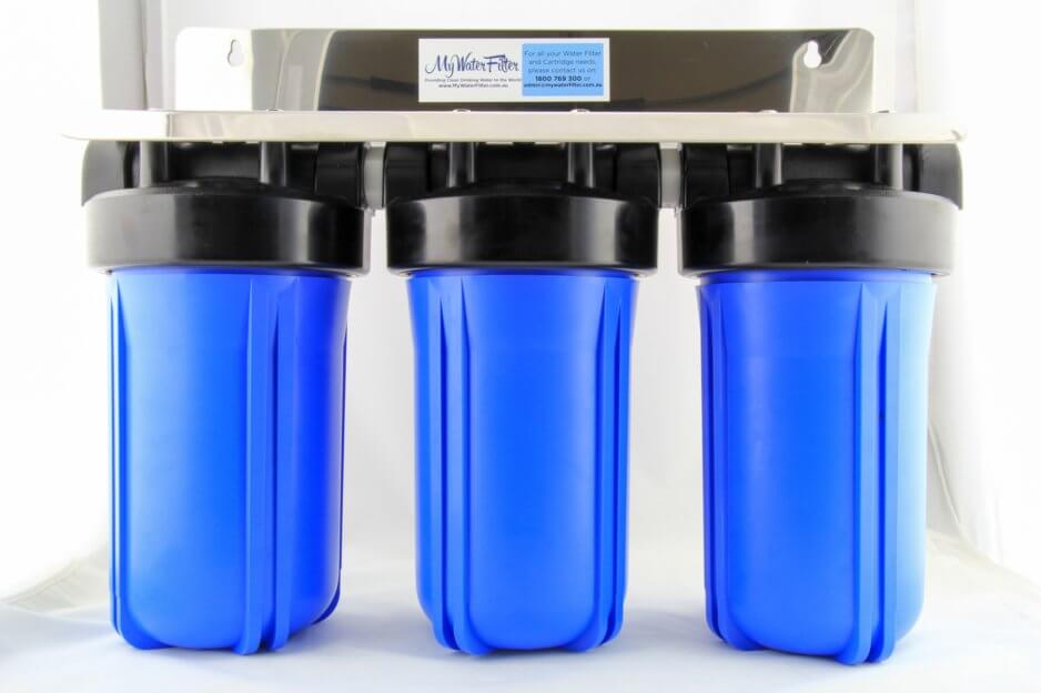 Three blue housings in black caps mounted on a stainless steel bracket make up the MWF 10" x 4.5" Triple Big Blue Whole House Water Filter System.