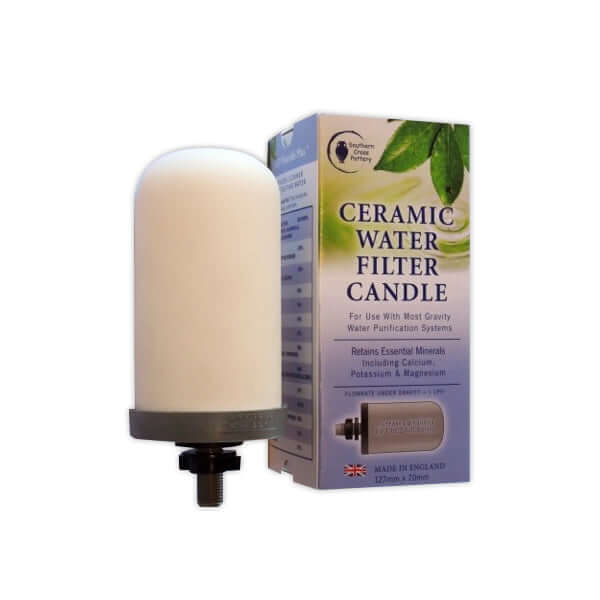 The white ceramic with black threaded cap of SCP Fluoride Plus Replacement Candle by Southern Cross Pottery is shown next to its box, which features product details and a green leaf design.