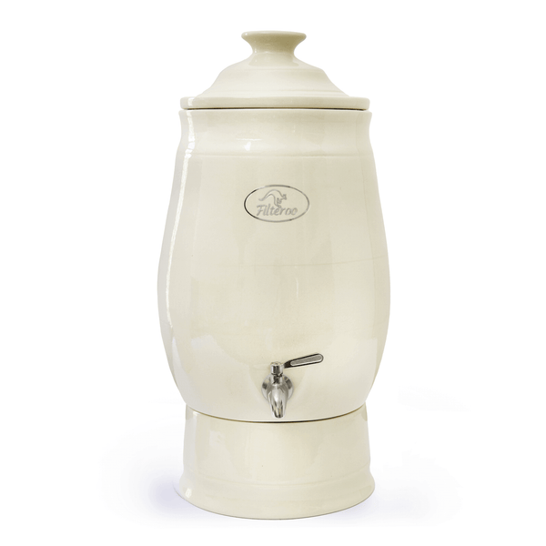 The Filteroo® Joey 12L Gravity Ceramic Water Filter, crafted by Filteroo, features a cream-colored stoneware body and a lid, utilizing gravity-fed technology for optimal filtration.