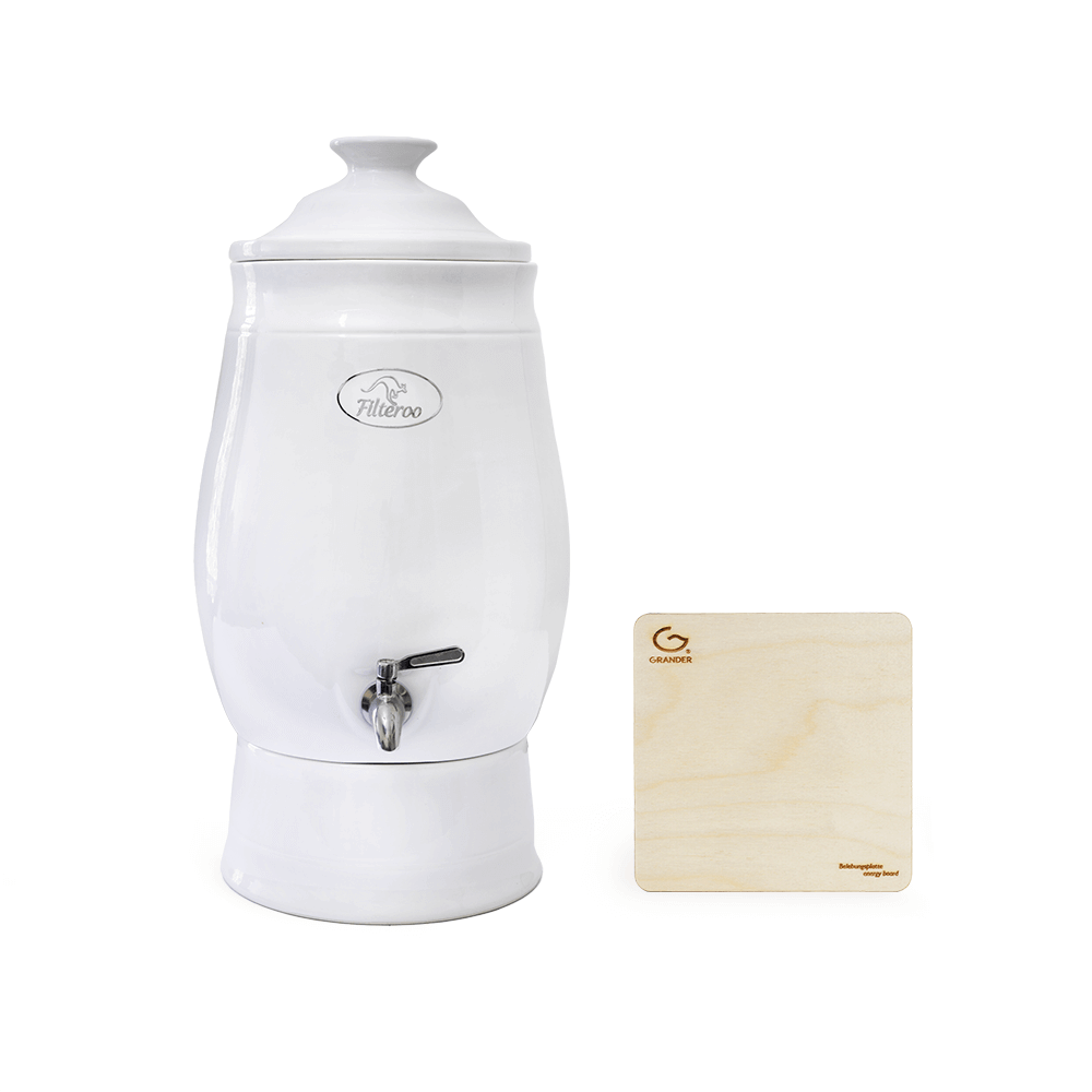 A Filteroo® Joey 12L Gravity Ceramic Water Filter with a tap is placed beside a wooden square block.