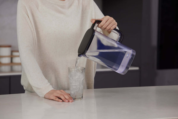 Philips Aquaporin Reverse Osmosis Water Station pouring water into an ice-filled glass.