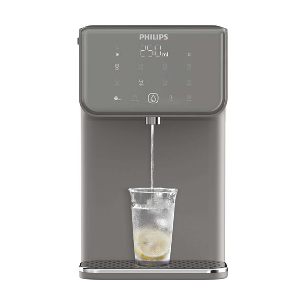 The Philips Compact Water Station, Hot & Cold ADD5981GR/79 with Micro X-Clean filtration, dispenses refreshing ice water into a glass, complete with a lemon slice.