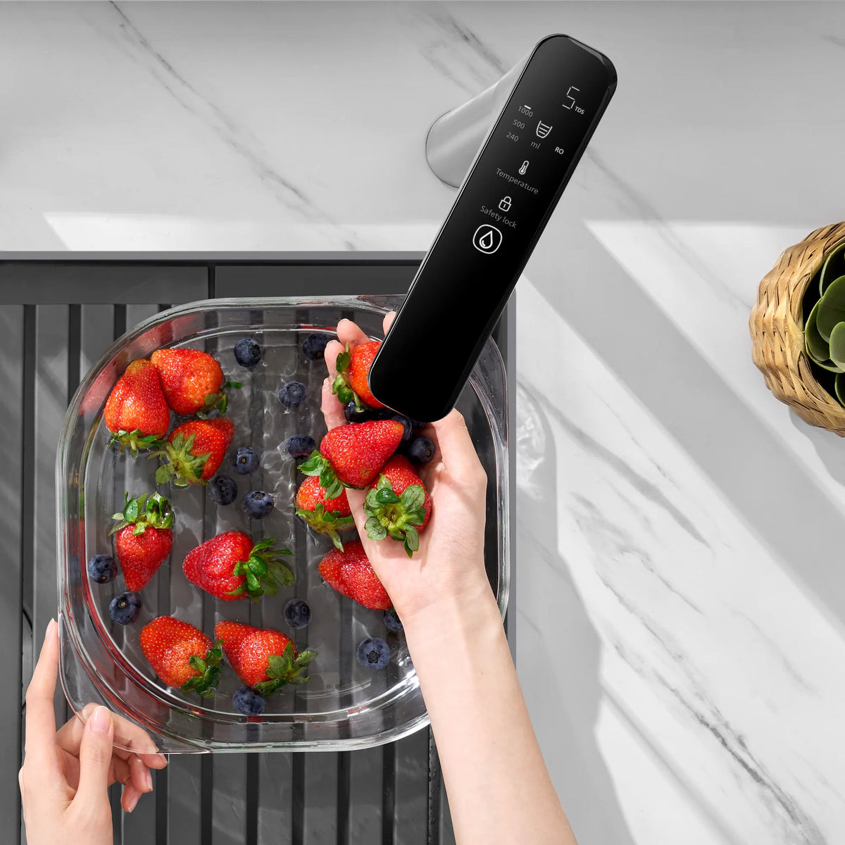 Philips AUT6104 7-temperature RO tap washing strawberries in a close-up lifestyle view.
