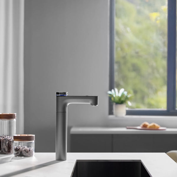 Side view of the Philips RO tap with a blue light ring on a kitchen counter, with a window and glass jars of coffee beans nearby.