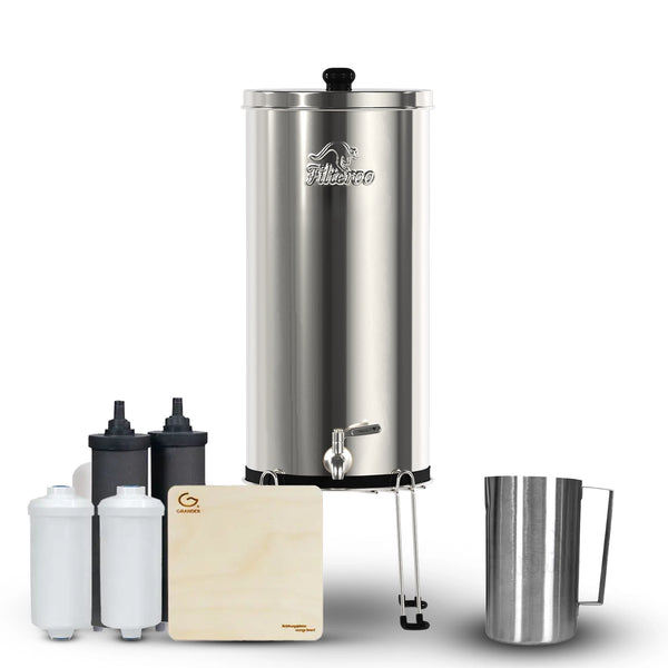 Filteroo® Superoo Stainless Steel Gravity Water Filter System with the two white Max Fluoride removal cartridges and two black carbon block cartridges alongside a wooden board known as the Grander Revitalising Board and a stainless steel jug