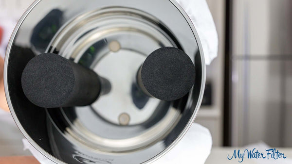 Close-up of two black cylindrical carbon block filters inside the Phoenix Stainless Steel Gravity Water Filter.