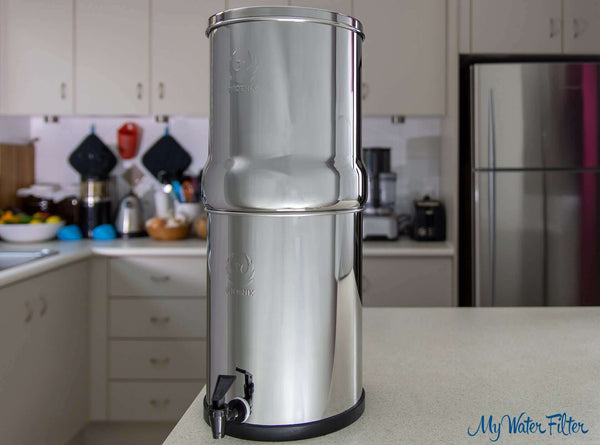 A Phoenix Stainless Steel Gravity Water Filter positioned in a kitchen setting, featuring a faucet at the bottom.