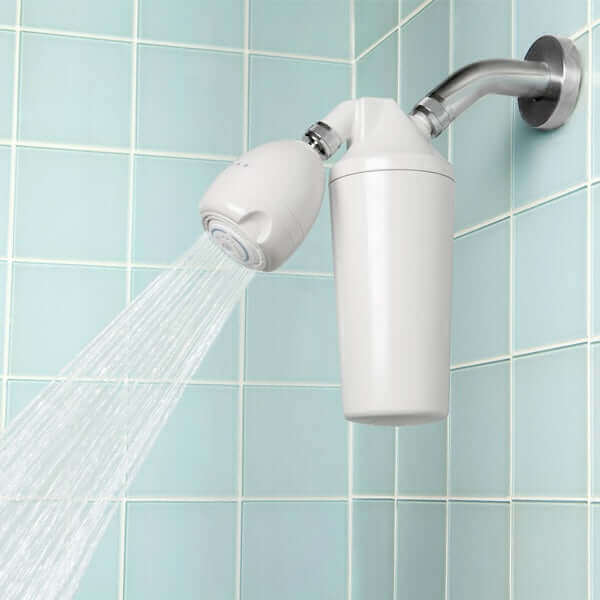 The Aquasana Premium Shower Filter by Aquasana sprays water in a tiled bathroom, promoting healthier hair by reducing chlorine exposure.
