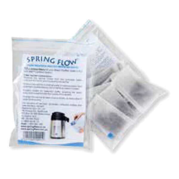 Packets of Spring Flow Steam Distiller Carbon Sachet Replacement, featuring instructional text and images on the packaging.