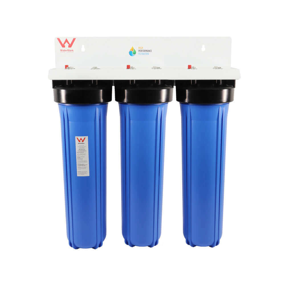 The HPF 20" x 4.5" Triple Big Blue Whole House Chloramine Reduction Water Filter System features three blue water filter housings mounted on a white bracket with WaterMark logo, designed for high volume systems and effective in reducing chloramine.